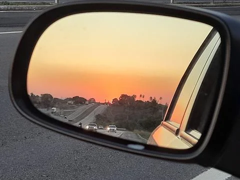 Sunset in the rearview mirror Stock Photos