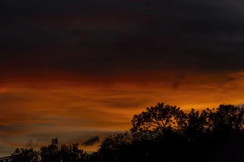 Sunset with red and blue dramatic sky, silhouette against the light, shadow.. Stock-Fotos