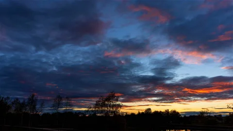 Sunset with red clouds over the trees Stock Footage 219955701