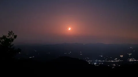 Sunset with red half moon Stock Photos