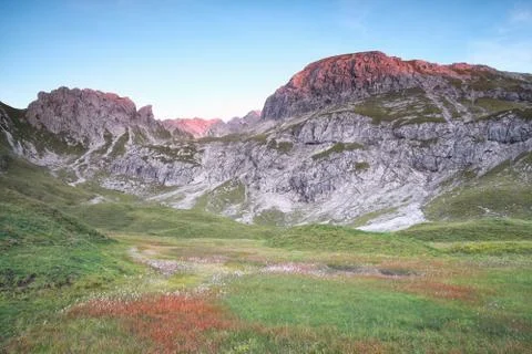Sunset red light on alpine peaks Stock Photos
