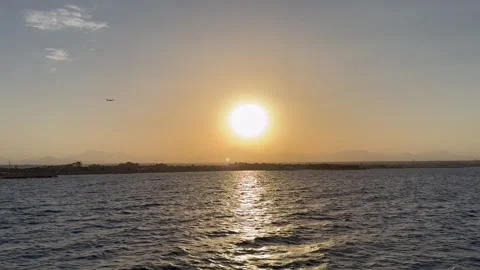 Sunset on Red Sea in Egypt with airplane in the sky Stock Footage 290178375