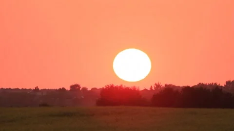 Sunset on red sky over cultivated field time-lapse Stock Footage 8556996