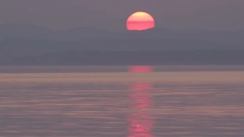 Sunset of the red sun over the mountains. reflection in water. ural, lake uvildy Stock Footage 136928865