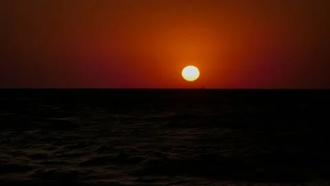 Sunset. The red sun sets over the horizon in a choppy sea. Stock Footage 201550132