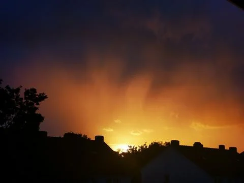 Sunset with reddish and blue clouds in central Europe Stock Photos