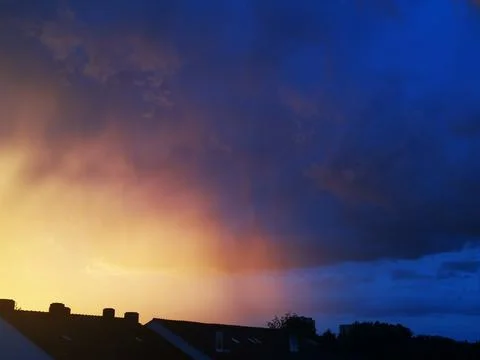 Sunset with reddish and blue clouds in central Europe Stock Photos