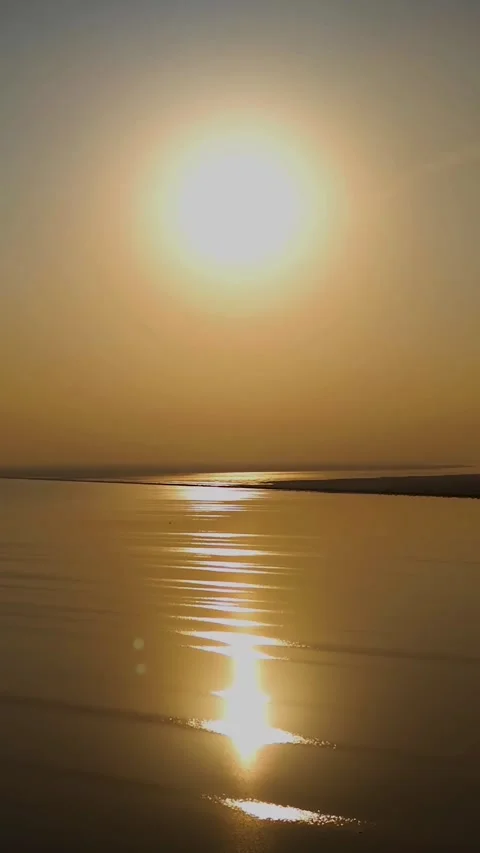 Sunset Reflected on Calm Beach Water Vertical Footage Stock Footage 328343623