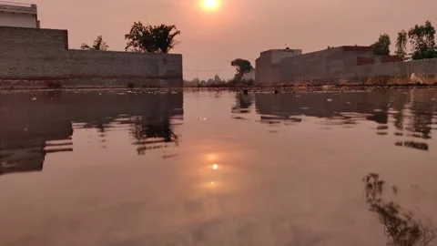 Sunset reflected in the flowing waters of a lake Stock-Footage 247734603