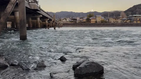 Sunset reflected on the historic bridge over the river, a peaceful atmosphere. Stock Footage 304845965