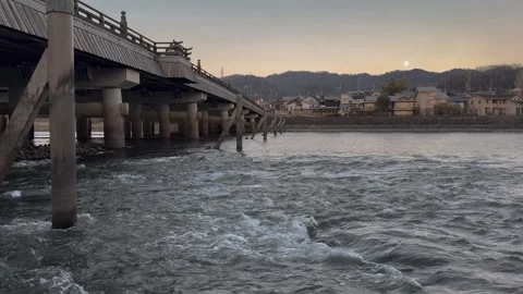 Sunset reflected on the historic bridge over the river, a peaceful atmosphere. Stock Footage 304845985