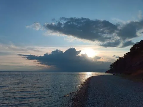 The sunset is reflected in Lake Baikal Stock Photos