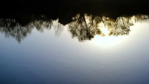 The sunset is reflected in the lake. The setting sun is reflected on the surface Video stock 195123031