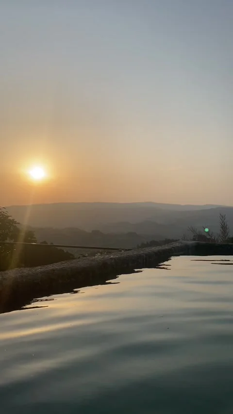 Sunset reflected in pool with distant hill and clear summer sky 🌅💧 動画素材 310965310