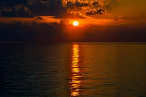 Sunset with reflected rays over the vast ocean Stock Photos