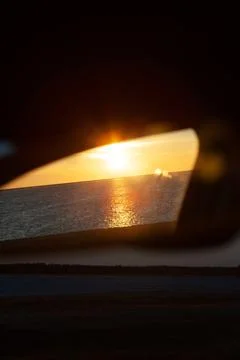 Sunset reflected in rear view mirror Stock Photos