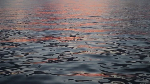 Sunset reflected on the sea water surface. Close up.	 Stock Footage 109230679