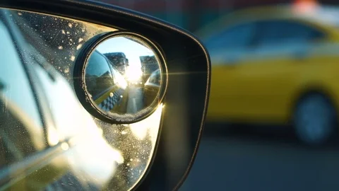 The sunset is reflected in the side mirror of a driving car Stock Footage 88002730