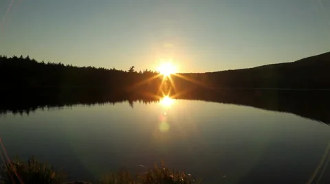Sunset reflected on surface of a lake Stock-Footage 44019905