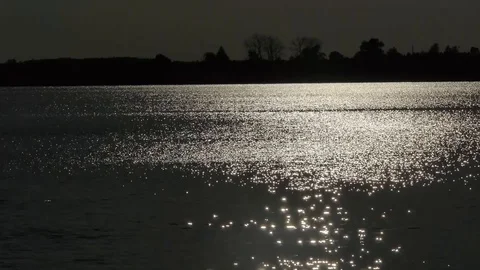 Sunset is reflected in the water surface of the lake Stock Footage 115320707
