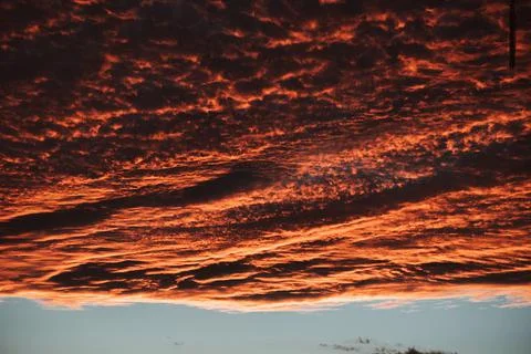 Sunset reflecting in the clouds, as if the sky is on fire Stock Photos