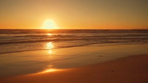 Sunset reflecting off of sandy beach Video stock 148633870
