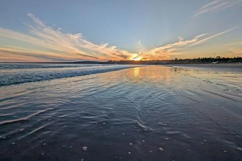 Sunset Reflecting on a sandy beach Stock Photos