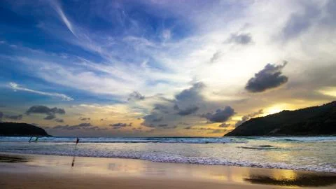 Sunset reflection on the beach and cloudy deep blue sky Stock Photos