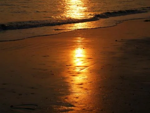 Sunset reflection on the beach Stock Photos