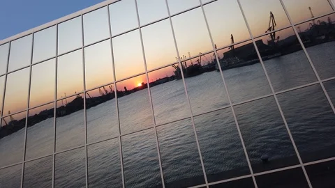 Sunset reflection on building mirror glass windows. Urban landscape. Stock Footage 114512923