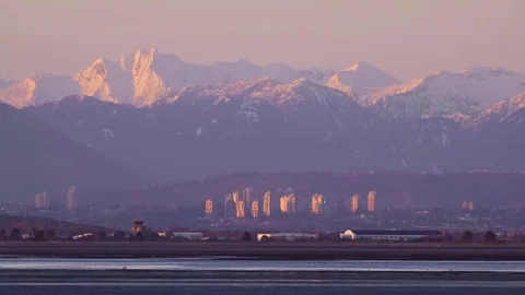 Sunset reflection on buildings in distance Video stock 74334128