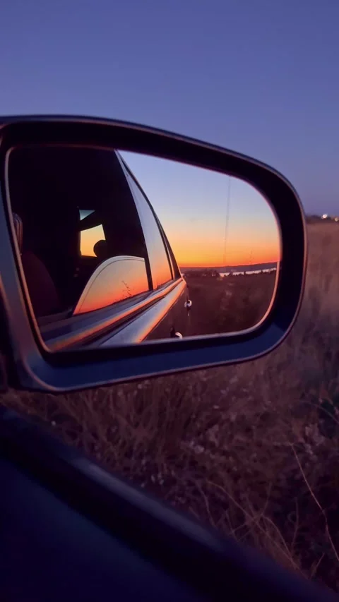 Sunset Reflection in Car Side Mirror During Twilight Road Trip Stock Footage 345124014