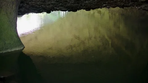 Sunset reflection on a lake in a cave system Stock Footage 89607676