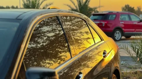 Sunset reflection on luxury car window Stock Footage 334098266