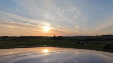 Sunset Reflection Over Rural Fields and Calm Water Stock Photos