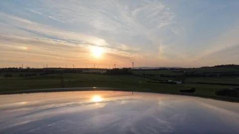 Sunset Reflection Over Rural Fields and Calm Water Foto stock