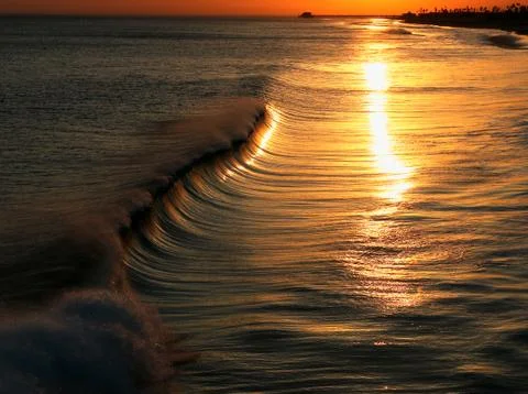 Sunset reflection over sea wave Stock Photos