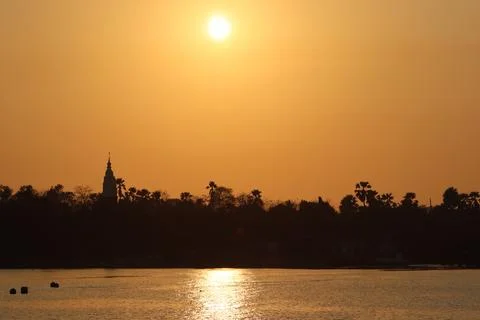 A sunset reflection on the river with orange sky background Stock Photos