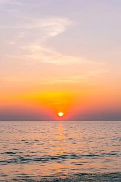 Sunset reflection sea. beautiful sunset behind the clouds and blue sky abov.. 스톡 사진