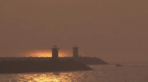 Sunset reflection, small boat enters harbour mouth port of Scheveningen Stock Footage 48417661