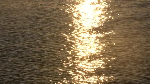 Sunset reflection sparkles on tiny ripples of sea water wave. Slow motion 스톡 동영상 97717762