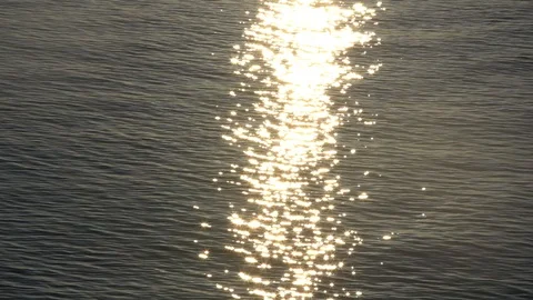 Sunset reflection sparkles on tiny ripples of sea water wave. Slow motion 스톡 동영상 98569843