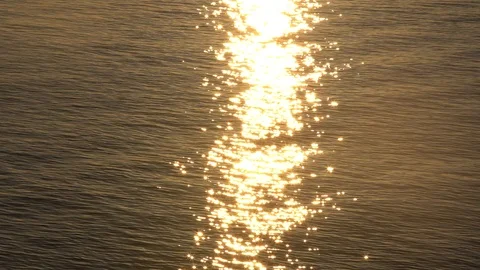 Sunset reflection sparkles on tiny ripples of sea water wave. Slow motion 스톡 동영상 99302897