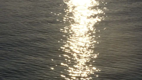 Sunset reflection sparkles on tiny ripples of sea water wave. Slow motion 스톡 동영상 101312832