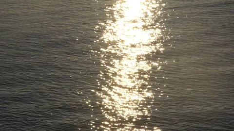 Sunset reflection sparkles on tiny ripples of sea water wave. Slow motion 스톡 동영상 103120795