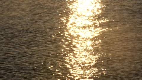 Sunset reflection sparkles on tiny ripples of sea water wave. Slow motion 스톡 동영상 109526468