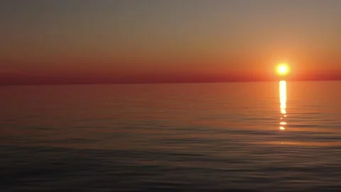 Sunset. Reflection of the sun in the water. Sailing ship in the open ocean. Stock Footage 134035742