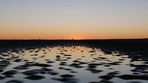 Sunset reflection in water at the beach Stock Footage 96077927