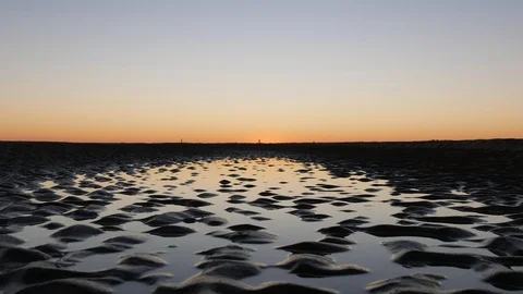Sunset reflection in water at the beach Stock Footage 96078294