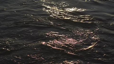 Sunset reflection on water close up Stock Footage 12657446